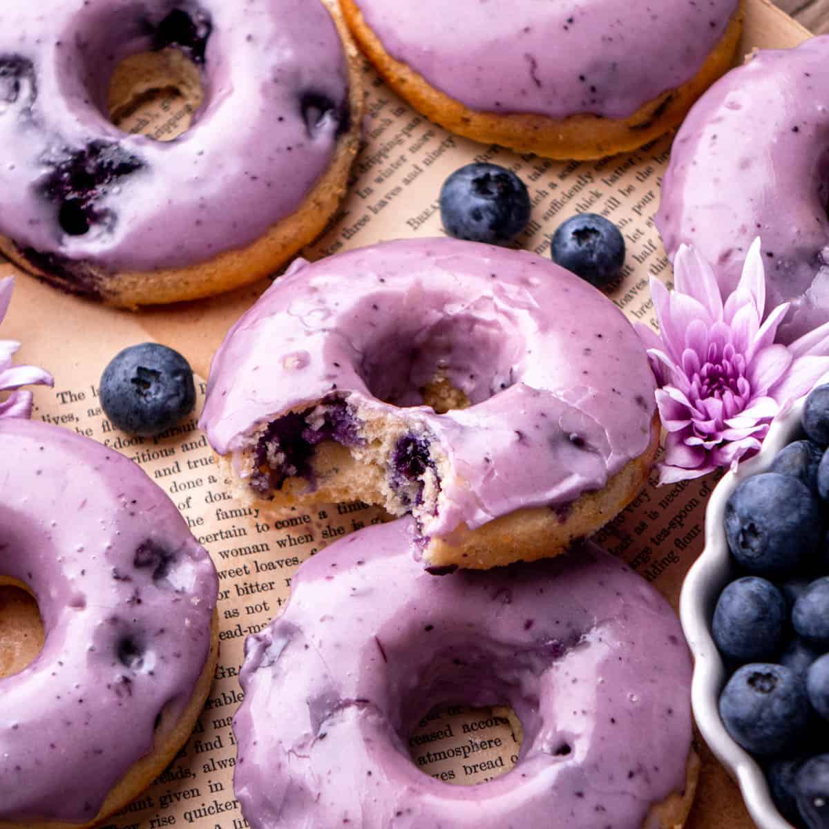 a blueberry jam donut with deep purple frosting and blueberries inside.