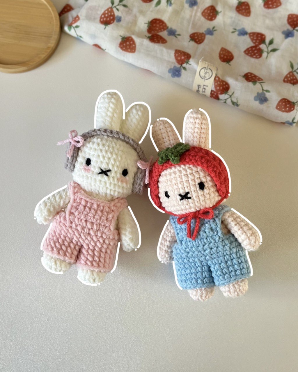 two cute crochet bunnies adorned in crochet clothes.
