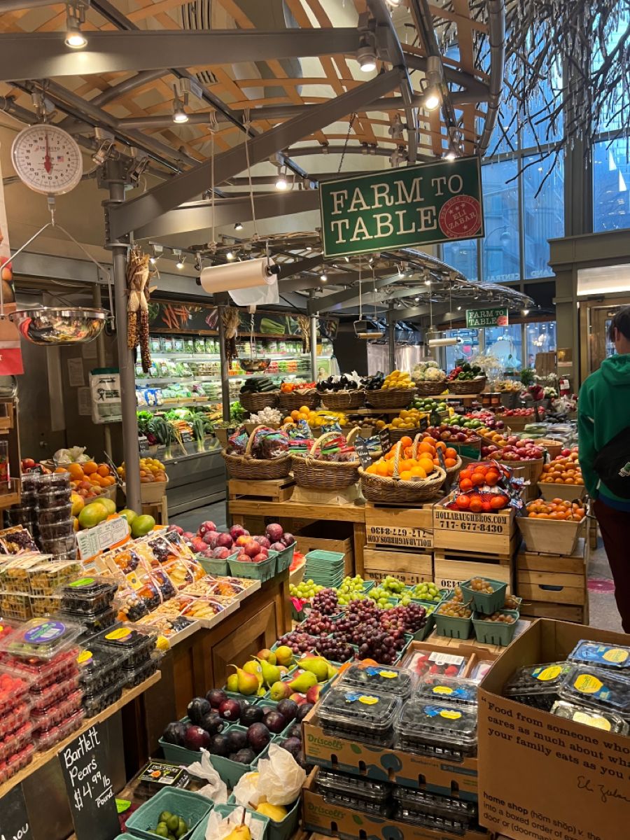 a farmers market with rows of baskets with fresh fruits and vegetables