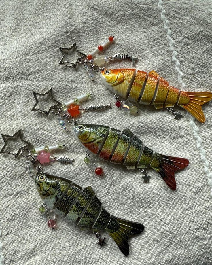 three fun, brightly colored sardine keychains on a keychain ring.